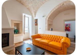 a living room with a couch and a fireplace at Rooftop Maisonette - Old Town by TrulloVista in Martina Franca