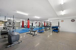 a gym with blue and red equipment in a room at Casa Lux in Aireys Inlet