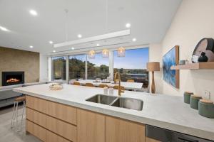 a kitchen with a sink and a living room at Casa Lux in Aireys Inlet +19 photos