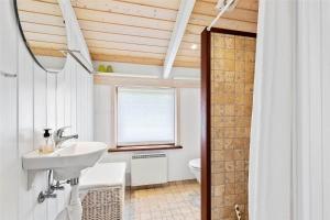 a bathroom with a sink and a toilet at 12292-Sjaellands-Odde-Lyngbugten-10 in Yderby
