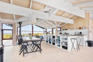a kitchen with a table and chairs in a room at 12292-Sjaellands-Odde-Lyngbugten-10 in Yderby