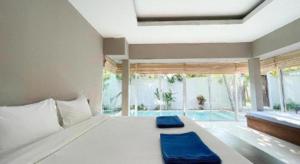 a bedroom with a large bed and a swimming pool at The Living Pool Villas in Ban Ko Khwan +193 photos