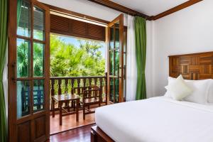 a bedroom with a bed and a balcony at Pierre Hotel in Siem Reap +26 photos