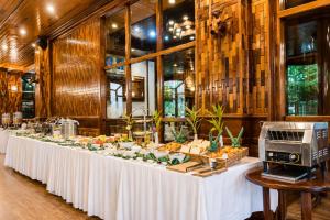 a long table with a buffet of food on it at Pierre Hotel in Siem Reap
