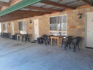 a group of tables and chairs in a room at Murray Gardens Motel in Stanthorpe