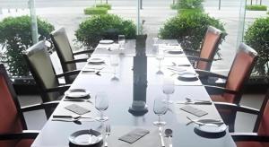 a long table with wine glasses and napkins on it at Wanyi Hotel in Dongguan
