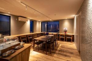 a restaurant with a table and chairs and windows at Hotel Cocoa - Vacation STAY 05828v in Sakura