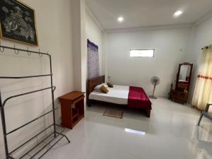 a bedroom with a bed and a mirror in it at Natures Nook Homestay in Etkandura