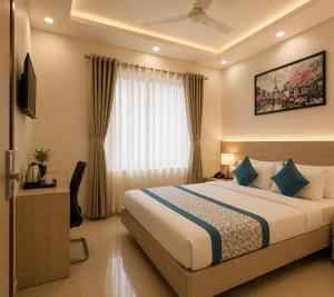 a hotel room with a bed and a television at Hotel The Vertigo in Noida