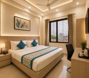 a hotel room with a bed and a window at Hotel The Vertigo in Noida +43 photos