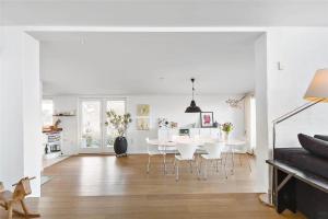 a white dining room with a white table and chairs at 13317-Asnaes-Mollestraedet-4 in Asnæs