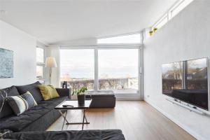 a living room with a couch and a large window at 13317-Asnaes-Mollestraedet-4 in Asnæs