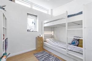 a white bedroom with bunk beds and a window at 13317-Asnaes-Mollestraedet-4 in Asnæs