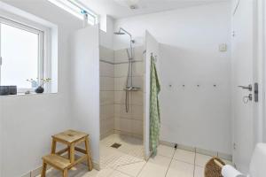 a white bathroom with a shower and a stool at 13317-Asnaes-Mollestraedet-4 in Asnæs +27 photos