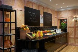 a buffet in a restaurant with fruit and juice at Meliá Paris Vendôme in Paris +47 photos