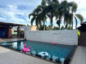 a swimming pool with a pink flamingo and a ball at The Horizon Villa Songkhla in Ban Mai