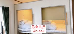 two mirrors in a room with a bed at HOSTEL198 Unisex dormitory cabin typeーVacation STAY68082v in Osaka +4 photos