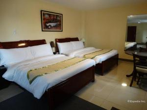 a hotel room with two beds and a table at Time Travellers Hotel in Manila +194 photos