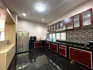 a large kitchen with stainless steel refrigerator and cabinets at The Horizon Villa Songkhla in Ban Mai +1 photo