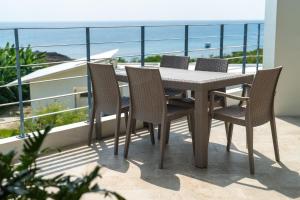 a table and chairs on a balcony with a view of the ocean at DESLIE - Vacation STAY 74346v in Sarahama +23 photos