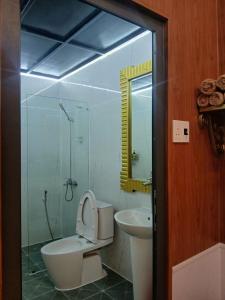 a bathroom with a toilet and a sink at paparazzi homestay in Xuyên Mộc