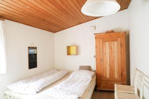 a bedroom with two beds and a wooden ceiling at 10033-1-Rorvig-Hjortevej-17 in Rørvig