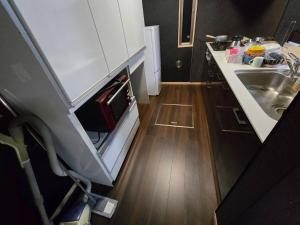 a small kitchen with a sink and a counter at Hamachidesu - Vacation STAY 15817 in Akiruno