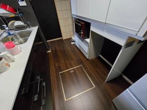 a small kitchen with a sink and a wooden floor at Hamachidesu - Vacation STAY 15817 in Akiruno +16 photos