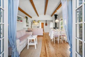 a living room with a couch and a table at FJ1401-Jaegerspris-Hovdiget-5 in Jægerspris +19 photos
