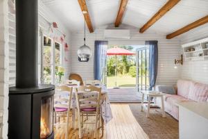 a living room with a fireplace and a table and chairs at FJ1401-Jaegerspris-Hovdiget-5 in Jægerspris