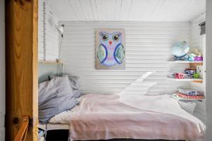 a bedroom with a bed in a room with white walls at FJ1401-Jaegerspris-Hovdiget-5 in Jægerspris