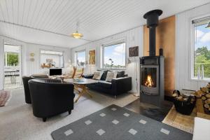 a living room with a fireplace and a couch at FJ2401-Skibby-Gogevaenget-31 in Skibby