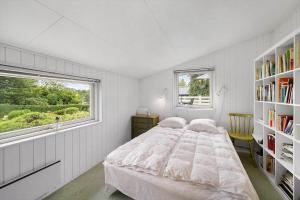 a white bedroom with a large bed and a window at FJ2401-Skibby-Gogevaenget-31 in Skibby