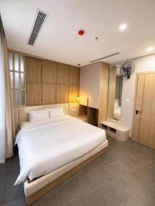 a bedroom with a large white bed and a tub at Solia Hill Hotel in Dong Hoi +72 photos