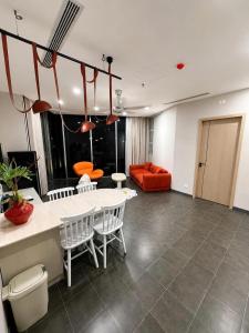 a living room with a table and chairs and a couch at Solia Hill Hotel in Dong Hoi