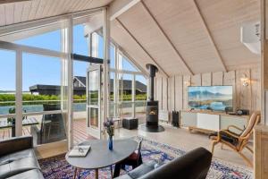 a living room with a couch and a table at FJ1600-Jaegerspris-Strandleddet-32 in Jægerspris
