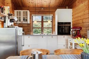 a kitchen with white cabinets and a wooden ceiling at FJ4306-Oro-Skovhojgardsvej-3 in Orø +22 photos