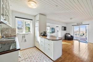 a kitchen with white cabinets and a counter top at FJ2403-Skibby-Hybenvaenget-27 in Skibby