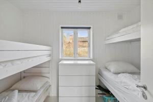 a white room with two bunk beds and a window at FJ2403-Skibby-Hybenvaenget-27 in Skibby