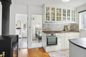 a kitchen with white cabinets and a stove at FJ2403-Skibby-Hybenvaenget-27 in Skibby