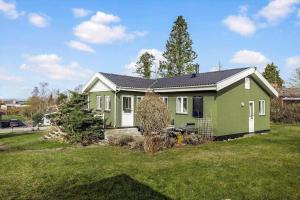 a green house in a yard with a grass field at FJ2403-Skibby-Hybenvaenget-27 in Skibby +18 photos