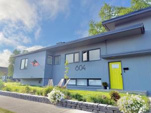 a house with a yellow door on the side of it at Alaskan Hideaway | Cozy & Adventure-Ready in Anchorage