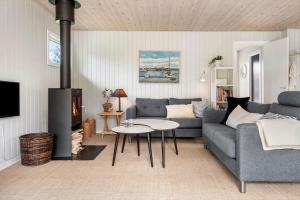 a living room with a couch and a fireplace at FJ4307-Oro-Gronnevej-6 in Orø