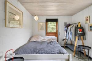 a small bedroom with a bed and a closet at FJ2002-Skibby-Stormgardsvej-11 in Skibby