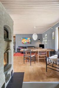 a living room with a table and a fireplace at FJ2002-Skibby-Stormgardsvej-11 in Skibby +24 photos