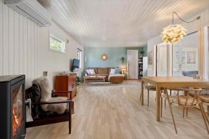 a living room with a table and a dining room at FJ1404-Jaegerspris-Strandstien-17 in Jægerspris