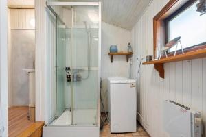 a shower in a bathroom with a glass door at FJ1404-Jaegerspris-Strandstien-17 in Jægerspris +22 photos