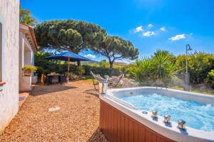 a hot tub in the backyard of a house at La Sciumara with beach access - Happy Rentals in Cannigione