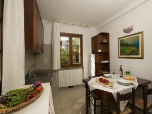a kitchen with a table with fruits and vegetables on it at Huge Holiday Home in Marina di Castagneto Carducci near Sea in Donoratico
