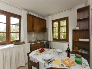 a kitchen with a table with food on it at Huge Holiday Home in Marina di Castagneto Carducci near Sea in Donoratico +32 photos